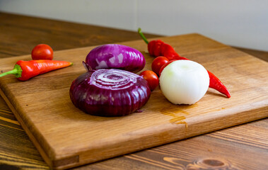 red and white onions on a wooden cutting board