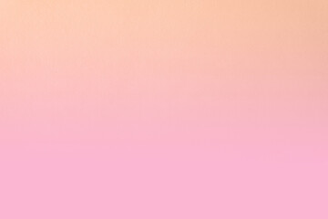 Pastel or pale orange gradation with light pink two tone color tone paint on blank recycled paper texture background