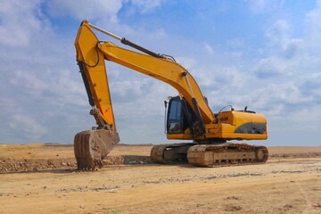 Fototapeta na wymiar excavator or backhoe on construction site and sky background