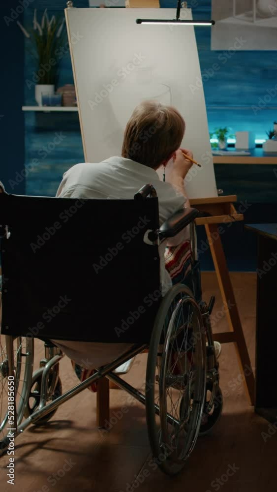 Poster vertical video: woman with chronic health condition drawing vase on canvas, using artistic skills to