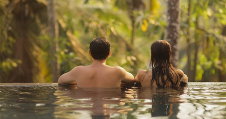 Couple in Love Together in Infinity Swimming Pool Outdoors During