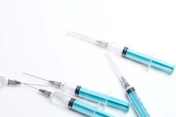 Fototapeta premium Medical syringe on a white background. A syringe for injection. The concept of health and beauty