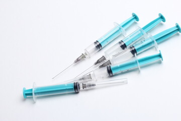 Fototapeta premium Medical syringe on a white background. A syringe for injection. The concept of health and beauty