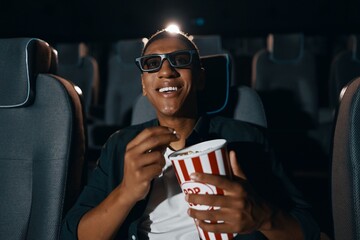 A man is watching a movie in the cinema comedy.