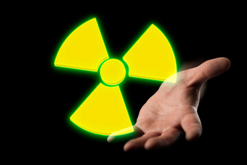 concept of radiation threat, a symbol of radiation hazard against the background of a hand...