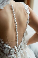 Corset of the bride's wedding dress close-up, fabric with lace and clasp