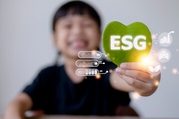 ESG text symbol on kid hands green leaf eco background, creative eco environment investment fund, future green energy innovation business trend.ESG of environmental Icon.