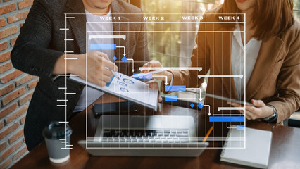 Project manager working and update tasks with milestones progress planning and Gantt chart scheduling diagram. business working with smart phone, tablet and laptop in office..