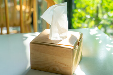 Wooden tissue box on the table in the restaurant.