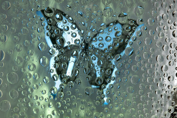 Malachite-blue spheres are located against the malachite-blue background with white-blue butterfly silhouette. Abstract fantasy. 3D render. 
