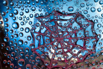 Striped spheres are located against the blue background with burgundy web silhouette. Space abstraction. 3D render. 