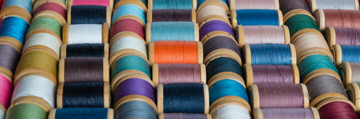 Multi-colored spools of thread close-up. Sewing threads multicolored background closeup	