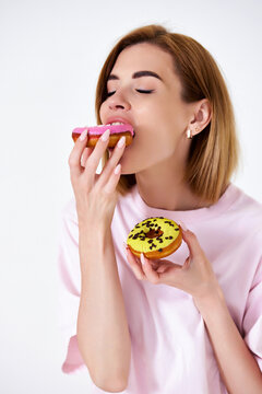 beautiful blonde woman with donuts on white background.