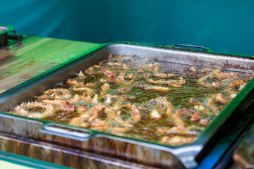 Street food cooked in a pan at the market.