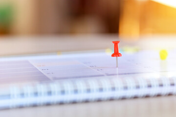 Calendar, Close-up red pin on blank desk calendar with office equipment concept of event planner or personal organization for business and appointment reminder and schedule planning.