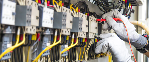 Electricity and electrical maintenance service, Engineer hand holding AC voltmeter checking...