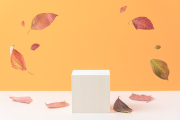 Wood podium on orange background with colorful falling leaves.  Concept scene stage showcase,...