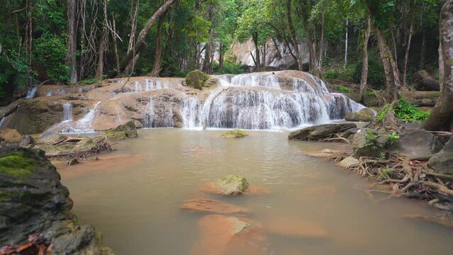 landscape waterfall clear water with rocks and root on natural to fresh relax with trees jungle or green forest on summer at Pha Tad Waterfall FL3 in KhuanSrinagarindra National Park with nature sound