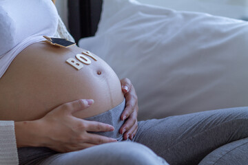 The expectant mother placed a gift and the word boy on her tummy after going for an ultrasound to...