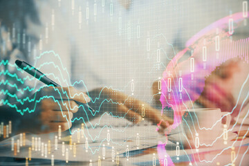 Double exposure of forex graph drawing over people taking notes background. Concept of financial analysis