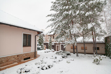 Snow lies in courtyard of house. View from porch