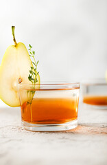 Cocktail with red syrup, pear and thyme 