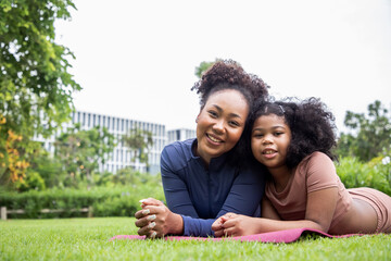 Yoga outdoor in the park. Young woman relax after doing yoga exercise outdoor at the day time with fresh air in the garden. Sport and exercise concept