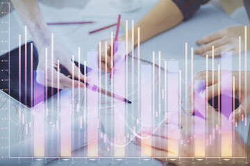 Double exposure of forex graph drawing and man and woman working together holding and using a mobile device. Trade concept.