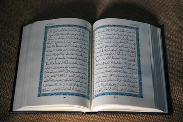 Obraz premium Indonesia - July, 2022 : The Quran, also romanized Qur'an or Koran, is central religious text of Islam, believed by Muslims to revelation from God (Allah). Classical Arabic. Sack, Blue. white. Open.