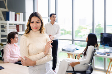 Young Asian female worker staff with colleagues male and female group coworker in casual working at workspace office, Back to the office concept