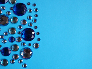 Crystal blue rhinestones on a blue lite background