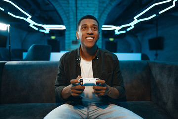 The player plays the console. Neon gaming room. © callisto
