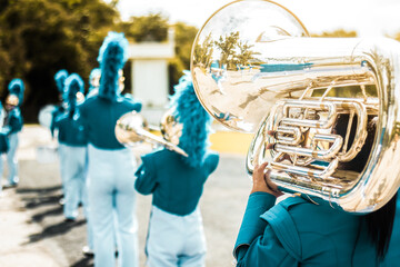 Group of students perform tuba, School band performs in marching band