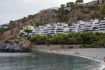One of the few places man can live in natures beauty. Cropped shot of a city on the coastline with mountains surrounding it. 
