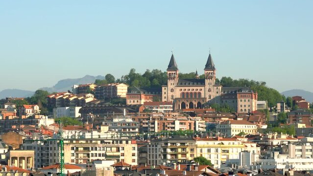 San Sebastian - Donostia. Buildings built at the top of the hills. The specific architecture of the Basque Country. View of The Diocese of San Sebastian, an Roman Catholic Church, at sunset