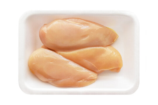 Raw chicken breast fillet on a white foam meat tray on white background.  