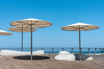 View of Tel Aviv Beach Promenade, Israel. Sunshades at sunset at Tel Aviv.