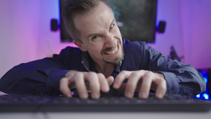 Online troll rage trashing on keyboard making faces in cyberspace