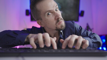 Online troll rage trashing on keyboard making faces in cyberspace