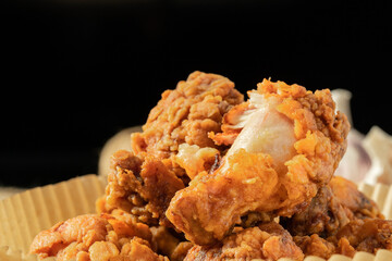 Fresh fried chicken legs on a simple background