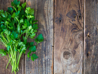 Fresh italian parsley on a wooden table. parsley.