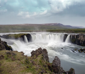 Fototapeta na wymiar Goðafoss waterfall in northern Iceland, located along the country's main ring road. The water of the river Skjálfandafljót falls from a height of 12 metres over a width of 30 metres.