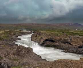 Goðafoss waterfall in northern Iceland, located along the country's main ring road. The water of the river Skjálfandafljót falls from a height of 12 metres over a width of 30 metres.