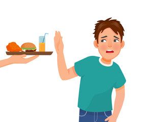 Young man on diet refusing to eat junk food like fried chicken and burger