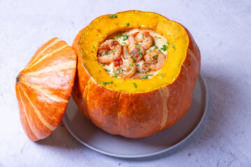 Pumpkin stuffed with shrimps and cheese, whole baked. Traditional Brazilian dish. Close-up.