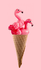 Two inflatable flamingo in waffle cone on pink background. Minimal  art summer creative poster.