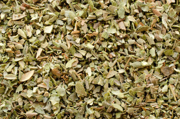 Origanum vulgare - aromatic spice, background, top view. Heap of dried marjoram leaves, top view, texture, background. Background of dry leaves of oregano, top view. Background for packing marjoram.