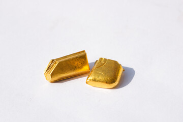 Pieces of Pure Gold Biscuit on isolated white background. Gold nuggets.