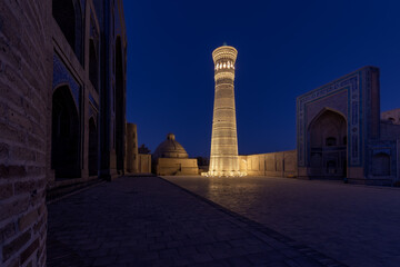 Poi-Kalyan square at night with brightly illuminated Kalyan minaret, Bukhara, Uzbekistan