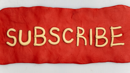 Plasticine red subscribe button on a white background.